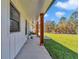 Long front porch featuring wooden pillars and stylish pendant lighting at 8827 Sw 137Th Ct, Dunnellon, FL 34432