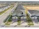 Aerial view of modern townhomes with a two-car garage, stone accents, and brick paver driveways at 953 Splash Shot Pl # 953, Davenport, FL 33896