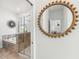 Stylish bathroom featuring a soaking tub, glass shower, and decorative round mirror at 953 Splash Shot Pl # 953, Davenport, FL 33896