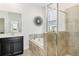 Modern bathroom showcasing tiled shower, soaking tub, sleek vanity, and designer mirror at 953 Splash Shot Pl # 953, Davenport, FL 33896