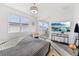 Bright bedroom with a bed, TV, furniture, and sliding glass doors to a balcony at 953 Splash Shot Pl # 953, Davenport, FL 33896