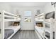 Bright bedroom features two bunk beds and a window, creating a cozy and inviting space for children at 953 Splash Shot Pl # 953, Davenport, FL 33896