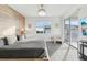 Comfortable bedroom showcasing a bed with gray bedding, a window, and a sliding glass door to a balcony at 953 Splash Shot Pl # 953, Davenport, FL 33896