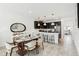 Open concept dining and kitchen area with stainless steel appliances and pendant lighting at 953 Splash Shot Pl # 953, Davenport, FL 33896