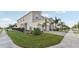 Side view of townhomes featuring well-manicured front yard, two-car garages, and brick paver driveways at 953 Splash Shot Pl # 953, Davenport, FL 33896
