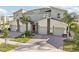 Modern townhome exterior features stone accents, neutral color scheme, paved driveway, and red entry door at 953 Splash Shot Pl # 953, Davenport, FL 33896