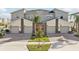 Modern townhome exterior with stone accents, red door, well-maintained landscaping, and paved driveway at 953 Splash Shot Pl # 953, Davenport, FL 33896
