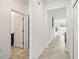 Bright hallway with tile flooring, connecting to the bathroom and offering a glimpse of the backyard at 953 Splash Shot Pl # 953, Davenport, FL 33896
