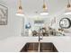 Open floor plan with kitchen island overlooking dining and living areas, perfect for modern living at 953 Splash Shot Pl # 953, Davenport, FL 33896