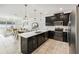 Modern kitchen features a breakfast bar, white countertops, and stainless steel appliances at 953 Splash Shot Pl # 953, Davenport, FL 33896