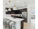 Contemporary kitchen featuring black cabinets, a white countertop, and a breakfast bar with seating at 953 Splash Shot Pl # 953, Davenport, FL 33896