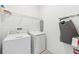 Well-lit laundry room featuring a washer, dryer, and storage shelves at 953 Splash Shot Pl # 953, Davenport, FL 33896