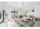 Open concept living room features neutral tones, modern lighting, and balcony access at 953 Splash Shot Pl # 953, Davenport, FL 33896