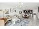 Open-concept living space with a dining area, sofa, and kitchen with stainless steel appliances at 953 Splash Shot Pl # 953, Davenport, FL 33896