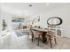 Sun-filled living area with dining space and sliding glass doors to a balcony at 953 Splash Shot Pl # 953, Davenport, FL 33896