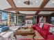 Cozy living room with coffered ceilings, fireplace, built-ins, and comfortable seating at 100 Blue Lake Ct, Longwood, FL 32779