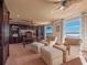 Bright and inviting office space with built-in bookshelves, two sitting chairs and beautiful water views at 100 Blue Lake Ct, Longwood, FL 32779