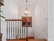 Close up of the staircase featuring a decorative wrought iron railing and chandelier at 100 Blue Lake Ct, Longwood, FL 32779