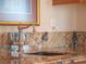 Detailed view of the wet bar area featuring the marble countertop and bronze faucet at 100 Blue Lake Ct, Longwood, FL 32779