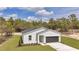 Beautiful one-story home featuring a two-car garage, manicured lawn, and attractive exterior at 12561 Sw 81St St, Dunnellon, FL 34432