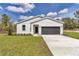 Charming single Gathering house boasting a manicured lawn, two-car garage, and attractive exterior at 12561 Sw 81St St, Dunnellon, FL 34432