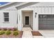 Close up shot of the home's entry showcasing manicured landscaping and a two-car garage at 12561 Sw 81St St, Dunnellon, FL 34432