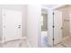 Bright hallway with wood-look floors offering seamless access to the bathroom at 12561 Sw 81St St, Dunnellon, FL 34432