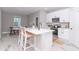 Bright kitchen featuring a large island with seating, stainless appliances, and white cabinetry at 12561 Sw 81St St, Dunnellon, FL 34432