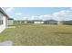 Expansive backyard featuring lush lawn and views of neighboring homes at 1324 Oak Valley Dr, Auburndale, FL 33823