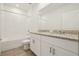 Modern bathroom featuring a double vanity with granite countertop and a tub at 1324 Oak Valley Dr, Auburndale, FL 33823