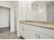 Bathroom features a dual sink vanity with granite countertops, walk-in closet and tile floors at 1324 Oak Valley Dr, Auburndale, FL 33823