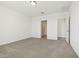 Bedroom with neutral carpet and view into bathroom and hallway at 1324 Oak Valley Dr, Auburndale, FL 33823
