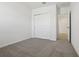 Clean bedroom featuring carpet floors and a closet with sliding doors at 1324 Oak Valley Dr, Auburndale, FL 33823