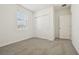 Well-lit bedroom with sliding closet doors, carpet flooring, and a window at 1324 Oak Valley Dr, Auburndale, FL 33823