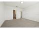 Spacious bedroom with neutral carpet and view into bathroom and hallway at 1324 Oak Valley Dr, Auburndale, FL 33823