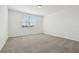Bright bedroom features a large window and neutral carpet at 1324 Oak Valley Dr, Auburndale, FL 33823