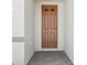 An inviting front door with decorative panels is framed by a neutral stucco exterior at 1324 Oak Valley Dr, Auburndale, FL 33823