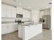 Modern kitchen with a central island, stainless steel appliances, and granite countertops at 1324 Oak Valley Dr, Auburndale, FL 33823