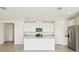 Bright, open kitchen with white cabinets, granite countertops, stainless steel appliances, and an island with sink at 1324 Oak Valley Dr, Auburndale, FL 33823