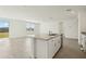 View of kitchen island with granite countertops, stainless steel sink, stainless steel dishwasher, and sliding glass door at 1324 Oak Valley Dr, Auburndale, FL 33823