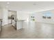 Modern kitchen with an island featuring stainless steel appliances and an open concept living area at 1324 Oak Valley Dr, Auburndale, FL 33823