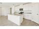Bright kitchen features granite countertops, stainless steel microwave, and white cabinets and an island with sink at 1324 Oak Valley Dr, Auburndale, FL 33823