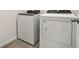 Laundry room area featuring a modern washer and dryer on tile flooring at 1324 Oak Valley Dr, Auburndale, FL 33823