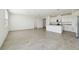 Open-concept living area with tile flooring, and a modern kitchen with white cabinets at 1324 Oak Valley Dr, Auburndale, FL 33823