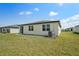 Spacious backyard with healthy green grass and a view of the home's exterior at 1337 Oak Valley Dr, Auburndale, FL 33823
