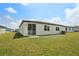 The backyard features a well-maintained lawn, a patio area, and a sliding glass door to the home at 1337 Oak Valley Dr, Auburndale, FL 33823