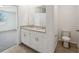 Well-lit bathroom with double vanities and granite countertops at 1337 Oak Valley Dr, Auburndale, FL 33823