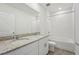 Clean bathroom boasts a double vanity with granite countertops and a shower-tub combo at 1337 Oak Valley Dr, Auburndale, FL 33823