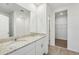Bright bathroom with double sink vanity, granite countertop, tile floor, and walk-in shower at 1337 Oak Valley Dr, Auburndale, FL 33823