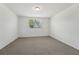 Bright bedroom with neutral carpet and a scenic view from the window at 1337 Oak Valley Dr, Auburndale, FL 33823